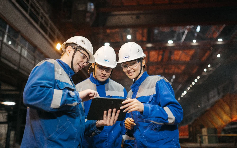 Manufacturing engineers collaborating on implementation and integration requirements in a factory environment